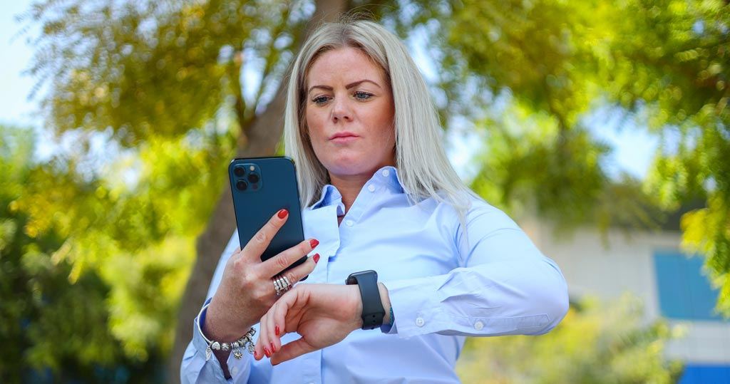 User looks at mobile phone and smart watch | Workz Group
