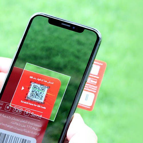 Mobile phone using camera to scan QR code on recharge card | Workz Group