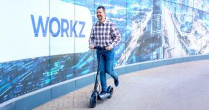 A man rides an electric scooter utilising eSIM IoT technology