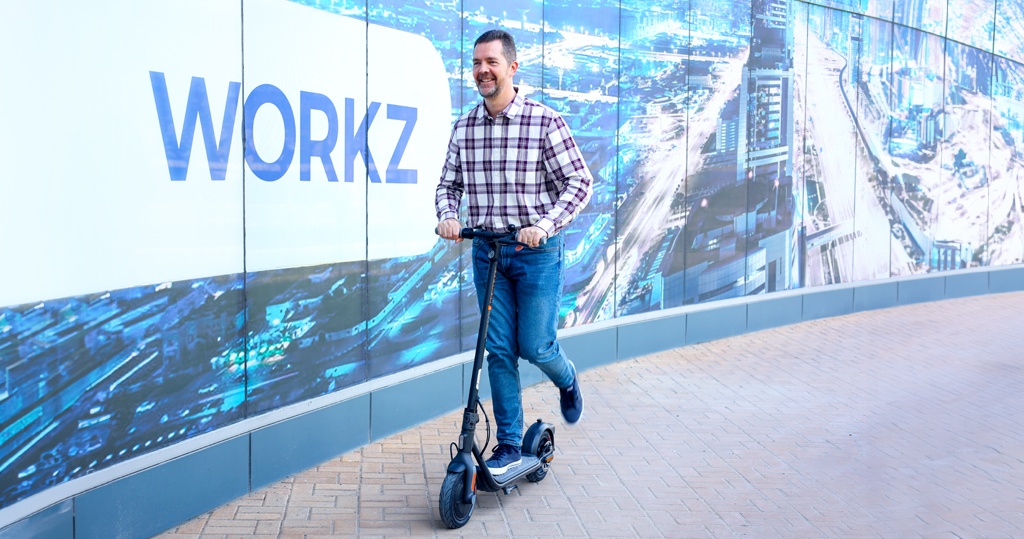 A man rides an electric scooter utilising eSIM IoT technology